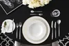 A formal table setting with plates, cutlery, and a floral arrangement. Náhled obrázku produktu