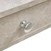 A close-up of a drawer knob on a piece of furniture with a stone-like texture. Voir les images du produit