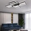 A modern living room with a blue sofa, a decorative shelf, and a large plant, illuminated by a geometric ceiling light. Náhľad obrázku produktu