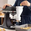 A person is using a KitchenAid stand mixer with a pasta extruder attachment to make pasta. Náhled obrázku produktu