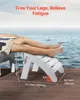 A person's legs resting on a white ottoman by the water. Voir les images du produit