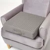 A gray orthopedic seat cushion is placed on a gray armchair. Náhled obrázku produktu