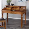 A wooden secretary desk with drawers and compartments is shown in a room with a gray textured wall and white curtains. Náhled obrázku produktu