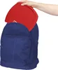 A hand is placing a red game board into a blue backpack. Náhľad obrázku produktu