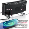 A black digital alarm clock with a projector is shown, with a smartphone being charged by it. Text overlays describe the power supply features. Produktbild-Vorschau
