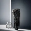 A black electric shaver and its detachable head are displayed on a light gray surface against a gradient gray background. Voir les images du produit