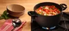 A pot of vegetable soup is simmering on a gas stove, with bowls and a ladle nearby. Náhľad obrázku produktu
