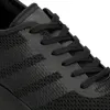 A close-up view of the laces and upper mesh of a black athletic shoe. Produktbild-Vorschau