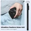 A person is putting a black phone case into their jeans pocket. Náhled obrázku produktu