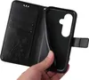 A hand is holding open a black floral patterned flip phone case, revealing the inner phone holder. Produktbild-Vorschau