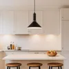 A modern kitchen island with pendant lighting and stools. Produktbild-Vorschau