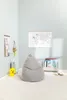 A child's room with a beanbag chair, a world map on the wall, and toys. Produktbild-Vorschau