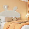A child's bed with a rabbit-shaped headboard and orange bedding. Produktbild-Vorschau