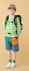 A young boy wearing a backpack and a striped shirt stands against a plain background. Produktbild-Vorschau
