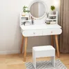 A white vanity table with a round mirror and wooden legs, set in a well-lit room. Anteprima dell’immagine prodotto