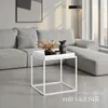 A modern living room scene with a sectional sofa and a white side table. Produktbild-Vorschau