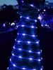A tree trunk wrapped in blue LED rope lights at night. Náhľad obrázku produktu