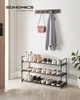 A shoe rack with shoes, a coat, and a purse in an entryway. Anteprima dell’immagine prodotto