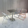 A small square table with three chairs around it, set against a textured wall. Anteprima dell’immagine prodotto
