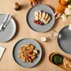 A table setting with plates of food, cutlery, and drinks, suggesting a meal. Produktbild-Vorschau