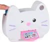 A finger presses a button on a white cat-shaped toy camera that is printing a pink card with cartoon images. Produktbild-Vorschau