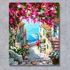 A painting of a scenic Mediterranean street leading to the sea, with vibrant pink flowers overhead. Produktbild-Vorschau
