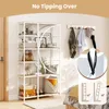 A white and natural wood bookshelf filled with various items, including bags, boxes, and decorative objects. A close-up inset shows a safety strap for the bookshelf. Produktbild-Vorschau