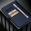 A close-up view of a blue leather iPhone case with card slots and currency. The case is placed on a dark, textured surface. Voir les images du produit