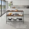 A kitchen island with cookware and food items, set in a modern kitchen with large glass doors leading to an outdoor area. Produktbild-Vorschau