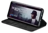 A smartphone in a black flip case is displayed, showing a movie poster on its screen. Produktbild-Vorschau