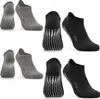 A collection of yoga socks in gray and dark gray. Produktbild-Vorschau