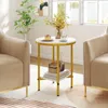 A round side table with a marble-look top and gold legs, placed between two beige armchairs in a living room setting. There is a slice of cake and a cup of coffee on the table, along with some decorative items on the lower shelf. Náhľad obrázku produktu