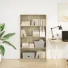 A bookshelf filled with books and storage boxes, placed in a room with a plant and a desk. Podgląd zdjęcia produktu