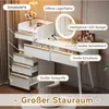 A white vanity table with gold accents, featuring drawers, an LED mirror, and makeup products. Produktbild-Vorschau