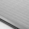 A close-up view of a gray pleated blind with white stripes. Produktbild-Vorschau