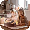 Two young girls are looking at a hamster cage. Náhľad obrázku produktu