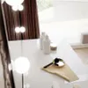 A white vanity table with makeup and lighting. Produktbild-Vorschau