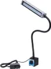 A black LED work light with a flexible arm and magnetic base, connected to a power adapter. Náhled obrázku produktu