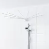 A retractable clothes drying rack mounted on a tiled wall above a shower head. Produktbild-Vorschau