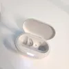 An open white charging case for wireless earbuds, showing the empty interior with charging contacts and indicator lights. Produktbild-Vorschau