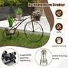 A decorative metal plant stand shaped like a bicycle, holding potted plants, displayed outdoors on grass. Anteprima dell’immagine prodotto