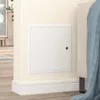A white access panel is installed on a cream-colored wall, next to a bed with a blue blanket. Voir les images du produit