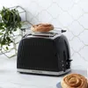 A black Russell Hobbs toaster with a bun on top, sitting on a kitchen counter. Náhled obrázku produktu