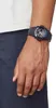 A close-up shot of a person's wrist wearing a black Casio G-Shock watch. Produktbild-Vorschau