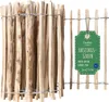 A close-up view of a hazelnut fence roll, with a green tag attached.