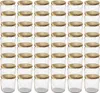 A grid of empty glass jars with gold lids. Voir les images du produit