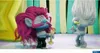 Two animated characters from the Trolls franchise are shown in a colorful, stylized environment. Produktbild-Vorschau