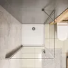 A top-down view of a modern bathroom with a shower cabin, toilet, and tiled floor. Produktbild-Vorschau