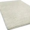 A close-up, angled view of a cream-colored shaggy rug. Náhled obrázku produktu
