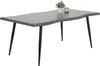 A dining table with a live edge top and black metal legs, with a small potted plant and a jar on top. Produktbild-Vorschau
